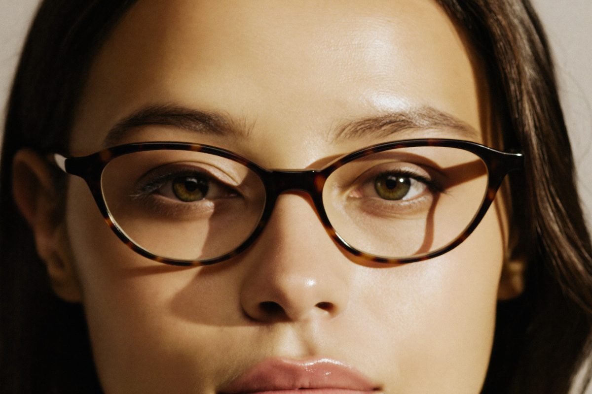 Woman with a heart-shaped face wearing cat-eye glasses frames that balance a narrower chin